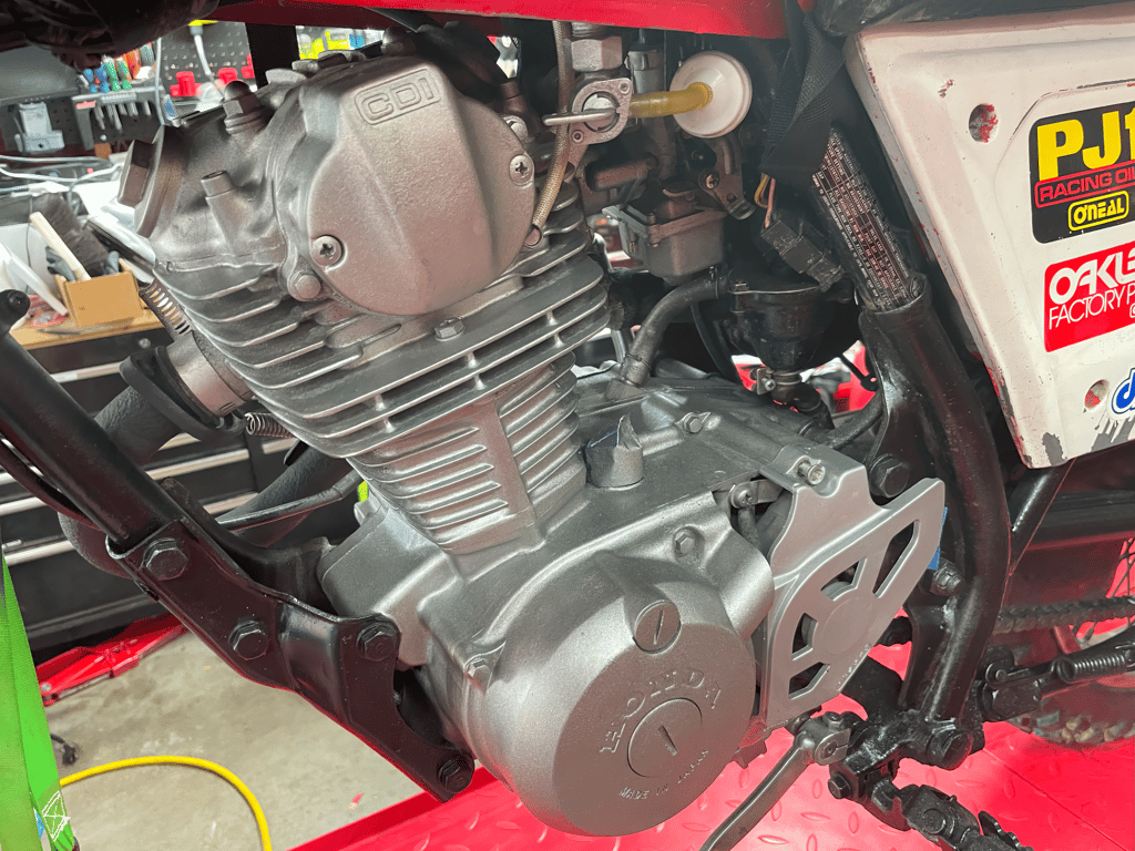 1979 Honda XL125s, during the rebuild: engine and sticker-covered side panel