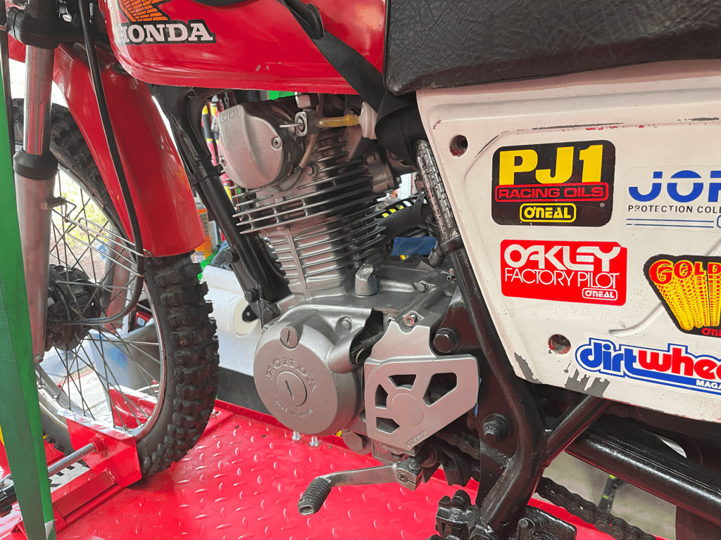 1979 Honda XL125s, during the rebuild: engine and sticker-covered side panel