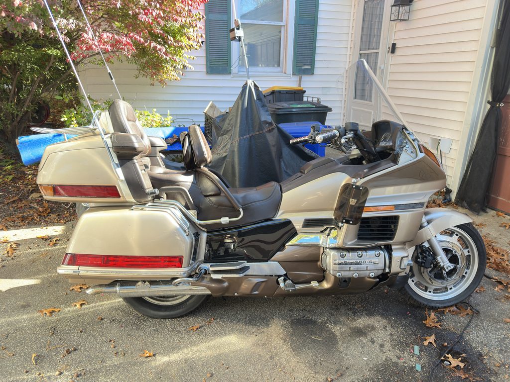 1988 Honda Gold Wing GL1500 Aspencade Kindle: left side of the tan Gold Wing parked outside against house siding