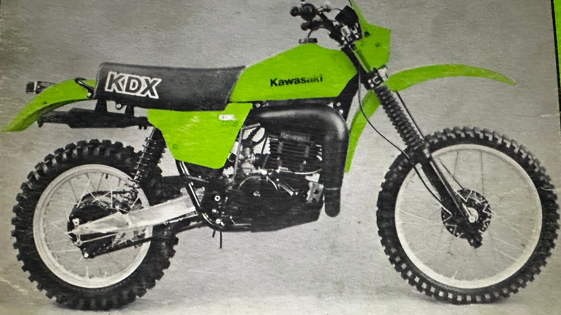 1979 Kawasaki KDX400-A1: side view of the green KDX400 with its KDX side panel