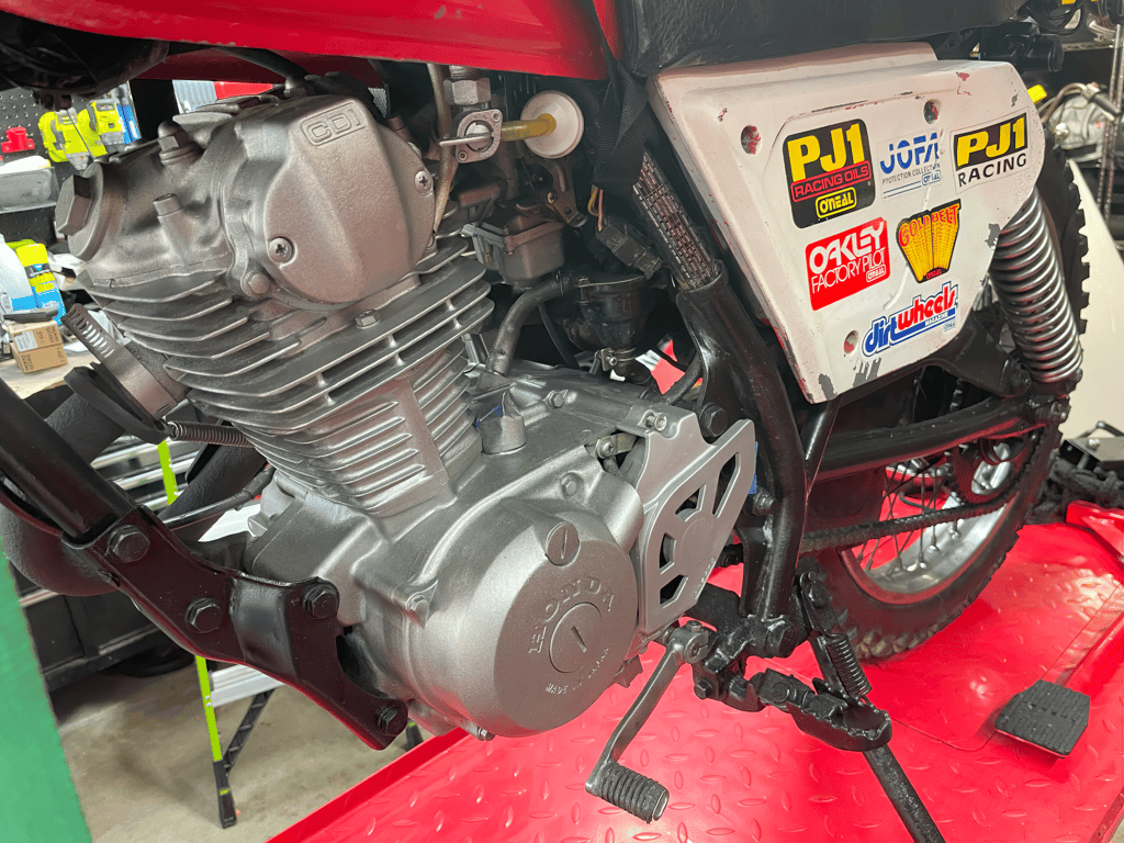 1979 Honda XL125s, during the rebuild: engine and sticker-covered side panel