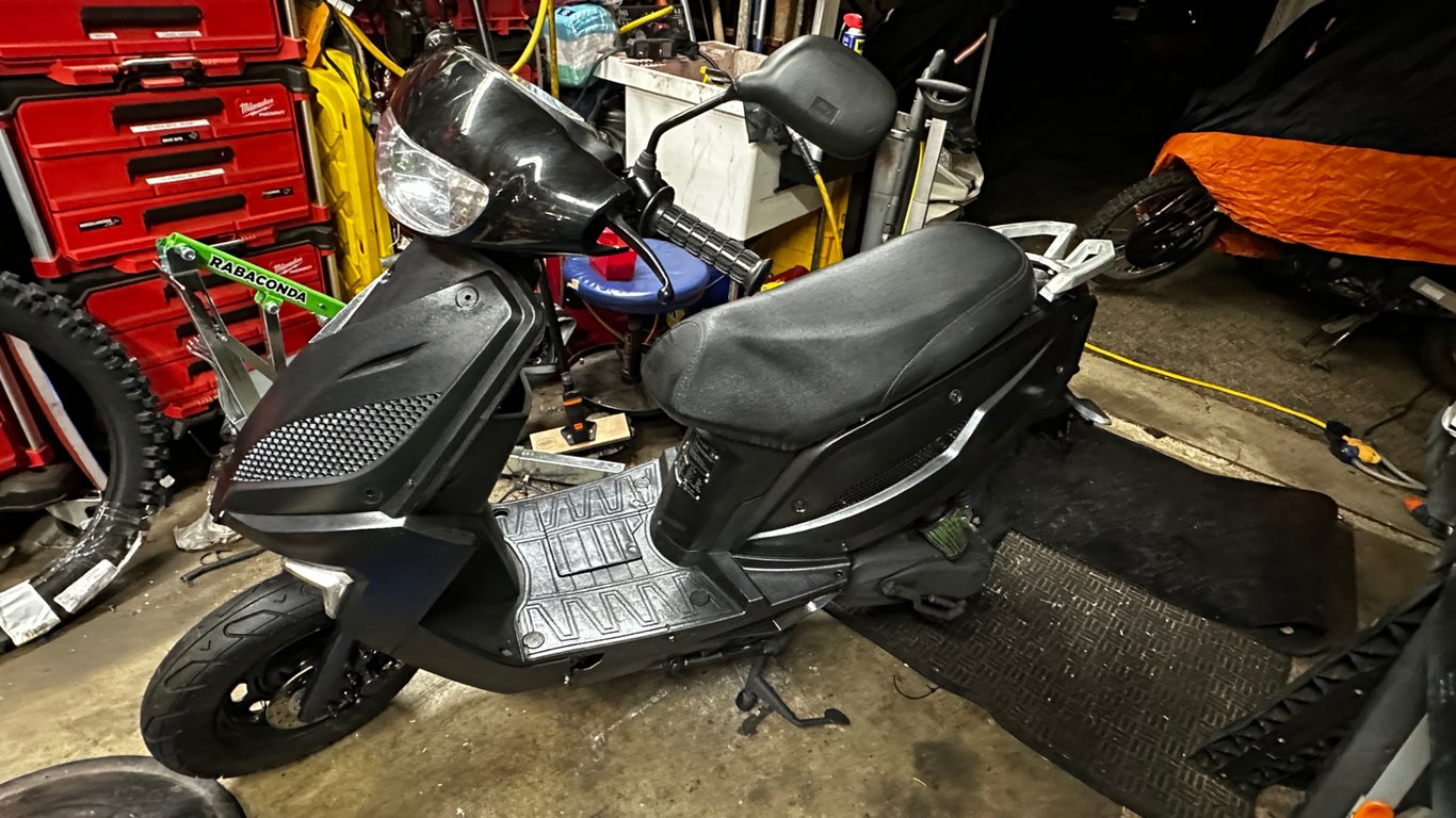 Tao Tao 50cc moped: side view of the black moped in the shop