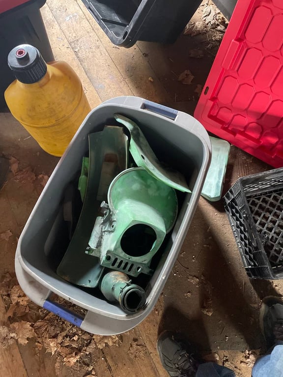 1979 Kawasaki KDX400-A1, before restoration: green plastic part in a storage bin